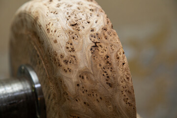 Closeup of round wooden turning blanks on lathe in workshop