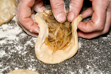 Woman cooking pies with cabbage