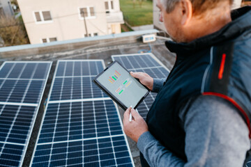 Engineer is checking with tablet app photovoltaic solar panels. Renewable energy , service, solar...