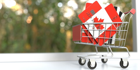 Bank card mockups with flags of Canada in a small shopping cart. 3D rendering