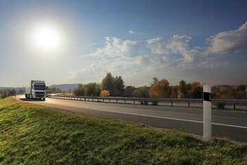 Landscape with a moving truck at sunset 