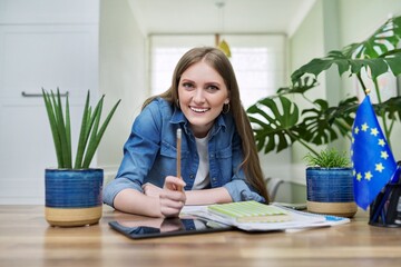 Young female student looking at webcam while talking.