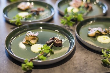 Preparing dinner. Roast beef, garlic, horseradish, blackberry, plate. Table, close-up, dining, background, lighting, people. Beautiful surroundings, adventure restaurant.