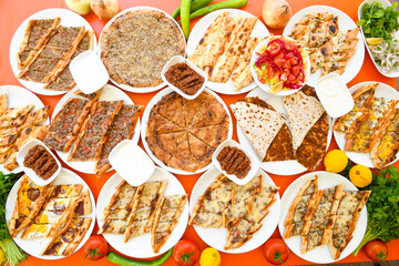 Traditional Turkish cuisine. Pizza, pita, pidesi, sucuk, hummus, kebab. Many dishes on the table. Serving dishes in restaurant. Background image. Top view, flat lay