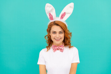 happy easter woman in bunny ears and bow tie on blue background