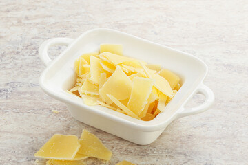 Sliced parmesan cheese heap in the bowl