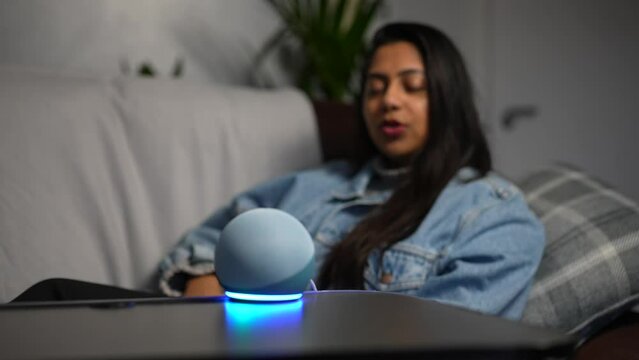 Asian Woman Gives Voice Command To Smart Control Activation Device At Home