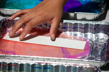 Colorful Oil Dip Art with a Paper Strip Remove from the Pan to Show a Beautiful Pattern