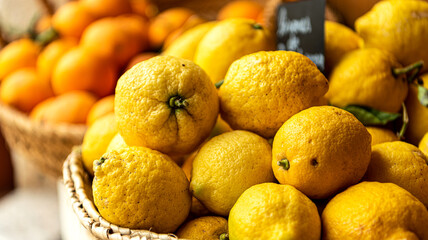 Lemons and oranges in baskets for sale