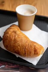 Coffe and croissant, french breakfast takeaway in bakery