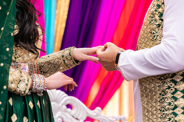 Fototapeta na wymiar Indian couple's exchanging rings hands close up
