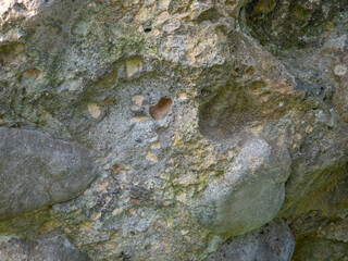 Background of uneven stone. Stone wall. Old masonry. Remains of  architecture