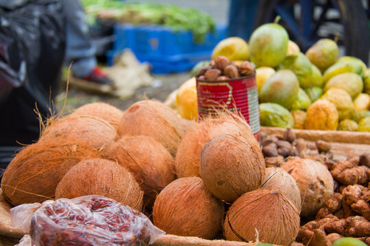 Dried coconuts with daylight, in the background tamarinds and passion fruit