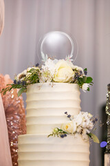 Beautiful white wedding cake decorated with flowers