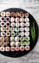 Sushi roll with salmon, tuna, avocado and cucumber. Traditional japanese food. A lot of maki. Sushi rolls.