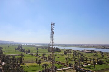 A green farm with trees and agriculture in Minya with ariel view from jabal el tayr in Egypt