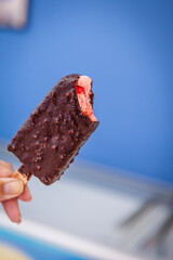 ."Eskimo" style popsicle, strawberry flavor, covered with chocolate. Copy space.