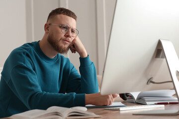 Fototapeta premium Online test. Man studying with computer at home