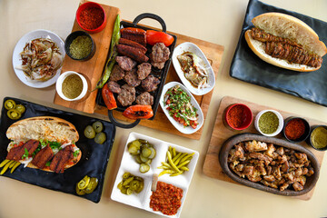 Delicious meat kebab with fresh vegetable salad served with variety of Turkish dishes and appetizers. Top view of assorted Turkish food and meze, tasty and healthy Mediterranean cuisine.