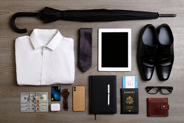 Business trip stuff on wooden surface, flat lay