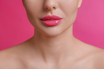 Fototapeta na wymiar Closeup view of woman with beautiful lips on pink background