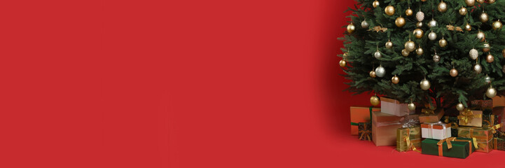 Beautifully decorated Christmas tree and gift boxes on red background, space for text. Banner design