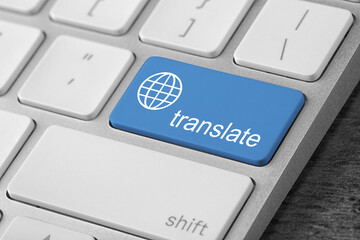 Blue button with word TRANSLATE on computer keyboard, closeup view
