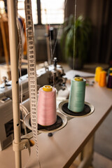 Reels of textile yarn blue thread at industrial weaving manufacturing machine