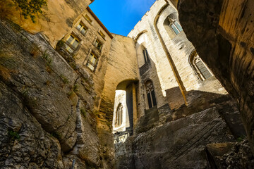 A narrow alley street with stone homes and apartments build over rock in the medieval old town of...