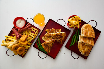 Table scene of assorted take out or delivery foods. Pizza, hamburgers, Doner, fried chicken and...