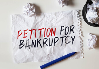 the inscription Petition for Bankruptcy on crumpled white paper