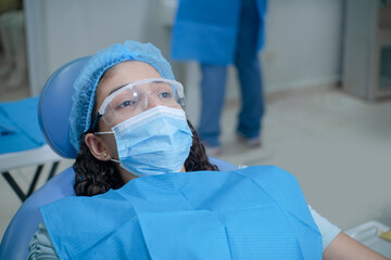 Fototapeta na wymiar Young latin american patient wearing face mask.