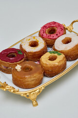 a plate with different donuts that have different glazes - Delicious fresh donuts on a plate 