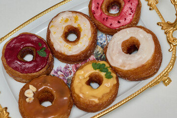 a plate with different donuts that have different glazes - Delicious fresh donuts on a plate 