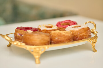 a plate with different donuts that have different glazes - Delicious fresh donuts on a plate 