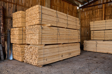 Boards sawn. The saw cut tree is folded. Stacks of plywood. Wood transportation.