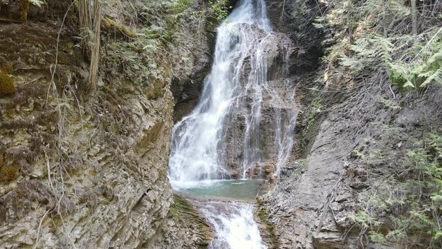 Tranquil and serene Margaret Falls cascading down a lush mountainside in Herald Provincial Park, British Columbia, Canada. Wide angle aerial shot 