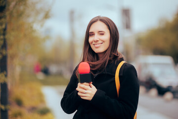  Reporter Holding a Microphone on the Street Doing her Job