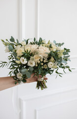Bridal bouquet in white shades for the wedding. Eucalyptus, rose, eustoma, dianthus