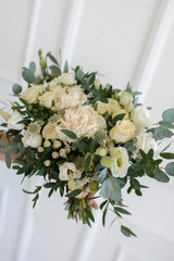 Bridal bouquet in white shades for the wedding. Eucalyptus, rose, eustoma, dianthus