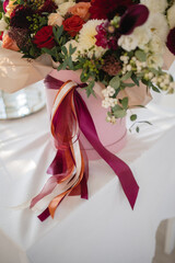Large gift arrangement with bright red and white flowers and ribbons