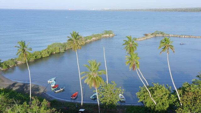 Small boats anchored on bay of Soco river mouth, Dominican Republic. Aerial panoramic view