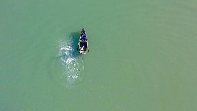 Aerial top-down forward over fisherman in Soco River mouth with fishing criminal method, Dominican Republic