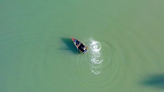 Fisherman in Soco River mouth with fishing criminal method, Dominican Republic. Aerial top-down directly above