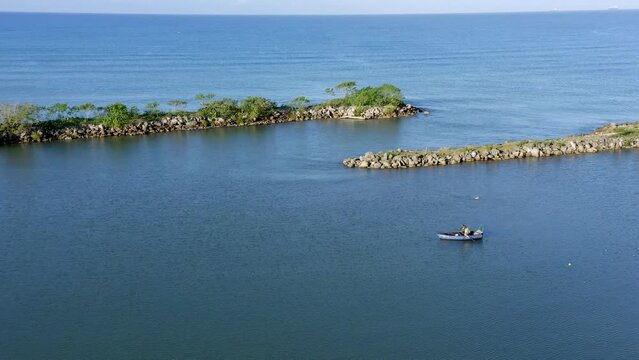 Fisherman in Soco River mouth, Dominican Republic. Aerial drone view