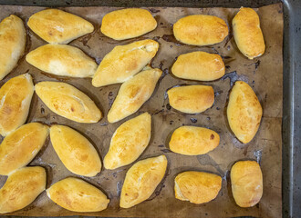 Place the freshly baked pies with the filling on a baking sheet covered with baking paper....