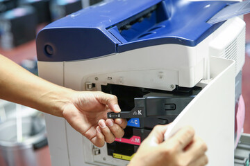 Technician hand open cover photocopier or photocopy to fix paper jam and replace ink cartridges for...