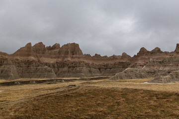 The rock formations at Badlands National Park sit under a cloudy sky
