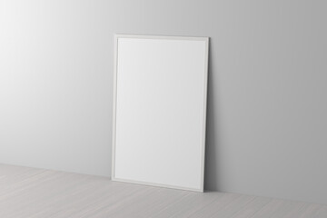 Mock up of vertical white frame on the floor with white wall.