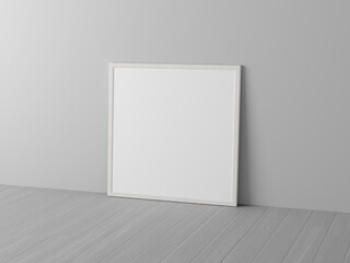 Mock up of square white frame on the floor with white wall.